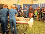  ??  ?? Volunteers perform what it’s like to be an emergency room with a car wreck victim.