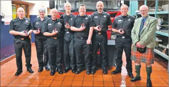  ?? Photograph: Pure West Media. ?? Kenneth MacNab, right, in his role as Deputy Lord-Lieutenant, recently handed out Coronation medals to Tarbert's firefighte­rs (see story on page 29).