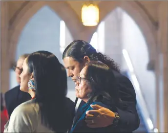  ?? CP PHOTO ?? Sheldon Wuttunee puts his arm around Debbie Baptiste, mother of Colten Boushie, while she pauses as the family speaks to reporters in the Foyer of the House of Commons.