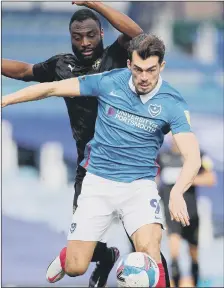  ??  ?? TOUGH GOING Pompey forward John Marquis holds off his marker during the 2-1 loss at home to Wigan Athletic.