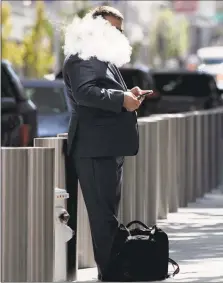  ?? File photo ?? A man smokes an ecigarette outside of the Transbay Transit Center in San Francisco.