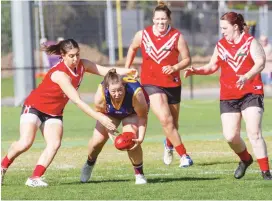  ??  ?? Left - Jenna Robertson wins the centre clearance against three opponents and looks to dish the handball off towards a teammate.
Photos - MICHAEL ROBINSON