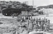  ?? Courtesy Fort Sam Houston Museum ?? The 38th Infantry arrives at Camp Bullis on Aug. 8, 1940, at the Old Bullis Road railway stop, between the Beckmann and Viva railroad stations. There were several such stops in the area, serving the community of Leon Springs, nearby ranches and a...