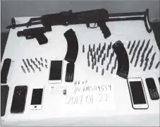  ??  ?? The AK-47, ammo and other items recovered (Police photo)