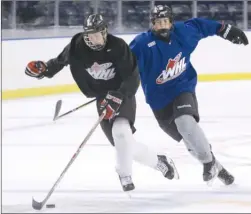  ?? GARY NYLANDER/The Okanagan Weekend ?? Kelowna Rockets forward prospect Steven Kesslering of Team Black pulls away from Ethan Grabowski of Team Blue during a rookie camp scrimmage Wednesday.