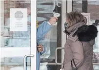  ?? FRANK GUNN THE CANADIAN PRESS ?? A woman has her temperatur­e taken as she arrives at the Roberta Place Long Term Care home in Barrie, Ont. The home has seen an outbreak of COVID-19 among staff and residents.