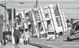  ?? Kyodo News/Sipa USA/USA TODAY NETWORK ?? A collapsed building is seen Tuesday in Wajima, Japan. Japanese media reports said tens of thousands of homes were destroyed.