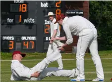  ?? ?? An Eversley fielder goes down with cramp