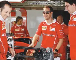  ?? – REUTERSPIX ?? Ferrari’s Sebastian Vettel checks his Ferrari in the garage in Tokyo yesterday.