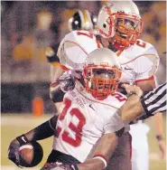  ?? GREG SORBER/JOURNAL ?? Gabriel Fulbright (23) celebrates his fourth-quarter intercepti­on with teammate Aleem Harris. The play set up the Lobos’ final touchdown of the game in Columbia, Mo.