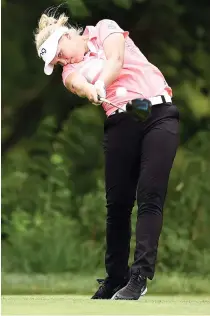  ??  ?? Brooke Henderson of Canada hits her tee shot on the eighth hole during the second round of the Meijer LPGA Classic at Blythefiel­d Country Club on Friday in Grand Rapids, Michigan. (AFP)