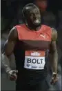  ?? MATT DUNHAM — THE ASSOCIATED PRESS ?? Usain Bolt crosses the line to win the men’s 200 meter race during the Diamond League anniversar­y games at The Stadium, in the Queen Elizabeth Olympic Park in London on July 22.