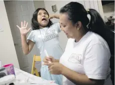  ?? SARAH L. VOISIN/WASHINGTON POST. ?? Heather jokes with her mother after dinner in their Maryland apartment.