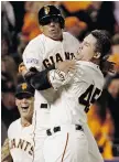  ?? DAVID J. PHILLIP/The Associated Press ?? San Francisco Giants’ Travis Ishikawa, right, celebrates his walk-off three-run home run in Game 5 of the NLCS Thursday.