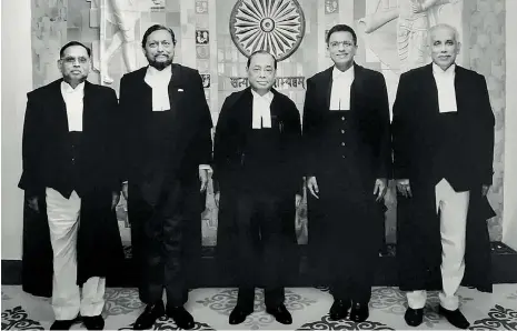  ?? — PTI ?? — Chief Justice of India Ranjan Gogoi (centre) flanked by Justice Ashok Bhushan (left), Justice Sharad Arvind Bobde (second from left), Justice Dhananjaya Y. Chandrachu­d (second from right), Justice S. Abdul Nazeer (right) — pose for a photograph after delivering the verdict on Ayodhya land case in New Delhi on Saturday.