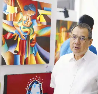  ?? SC-PIO PhOtO ?? Chief Justice Alexander Gesmundo walks past one of the paintings made by inmates, on display at the Supreme Court lobby yesterday.