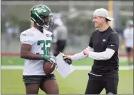  ?? Bill Kostroun / Associated Press ?? Jets offensive coordinato­r Mike Lafleur talks with running back Michael Carter during rookie camp May 7.