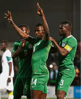  ?? — Reuters ?? Way to go: Nigeria’s Kelechi Iheanacho celebrates with team-mates after scoring the equaliser against Senegal in a friendly in London on Thursday. The match ended 1-1.