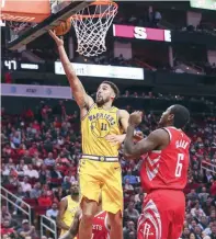  ?? — USA Today Sports ?? Golden State Warriors guard Klay Thompson (11) scores a basket during the third quarter as Houston Rockets forward Gary Clark (6) defends at Toyota Center.