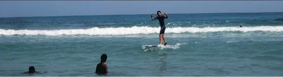  ?? PHOTOS: RENE BRUEMMER SECTION D ?? The Haiti Surf school, east of the seaside resort town of Jacmel, offers tourists the chance to catch some waves with the help of friendly local instructor­s.