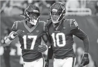  ?? Karen Warren / Staff photograph­er ?? Texans wide receiver DeAndre Hopkins, right, celebrates his touchdown catch against the Lions with Vyncint Smith, who later got one of his own Saturday night at NRG Stadium.