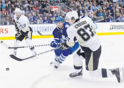  ?? CHRIS YOUNG/THE CANADIAN PRESS FILES ?? Sidney Crosby, right, and Phil Kessel, centre, are teammates on the Penguins now.