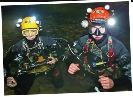  ??  ?? Expertise: British Divers John Volanthen, left, and Rick Stanton. Above: The Wild Boars and coach before they became trapped in the treacherou­s cave