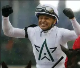  ?? JEFF ROBERSON — THE ASSOCIATED PRESS ?? Mike Smith celebrates after riding Justify to victory during the 144th running of the Kentucky Derby horse race at Churchill Downs Saturday in Louisville, Ky.