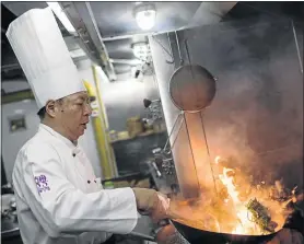  ?? PHOTO: OHANNES EISELE / AFP PHOTO ?? Master chef of Canton 8 restaurant, Jie Ming Jian, cooks vegetables in the kitchen of the restaurant.