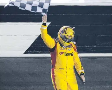  ?? Jared C. Tilton Getty Images ?? MICHAEL MCDOWELL, driver of the No. 34 Ford, celebrates with the checkered flag after winning the rain-delayed running of NASCAR’s season-opening Daytona 500. It was his first Cup Series victory.