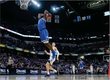  ?? AP PHOTO BY AJ MAST ?? Duke forward Zion Williamson (1) goes up for a dunk in front of Kentucky guard Tyler Herro during the first half of an NCAA college basketball game at the Champions Classic in Indianapol­is on Tuesday, Nov. 6.