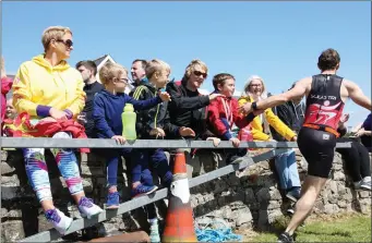  ??  ?? Supporting athlete Kevin McMoreland during the Mullaghmor­e Tri.