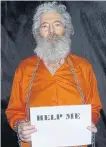  ?? AFP ?? Ex-FBI agent Robert Levinson, shackled and holding a sign.