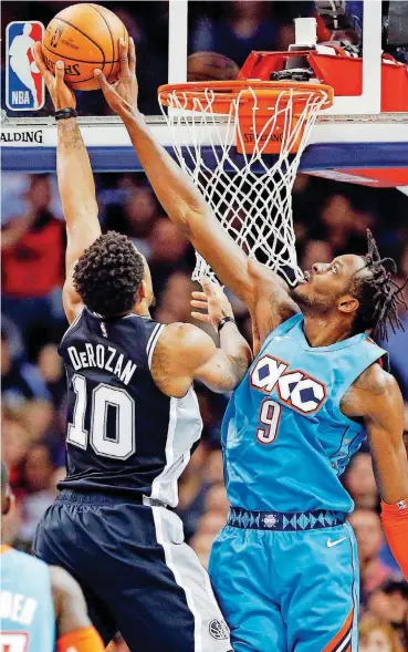  ?? THE OKLAHOMAN] [PHOTO BY NATE BILLINGS, ?? Oklahoma City’s Jerami Grant, right, blocks a shot by San Antonio’s DeMar DeRozan during Saturday night’s victory over the Spurs at Chesapeake Energy Arena. The Thunder ranks among the best defensive teams in the NBA.