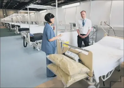  ?? PICTURE: PA WIRE ?? NHS England chief Simon Stevens visits the ExCel centre, London, which is being made into a temporary hospital.