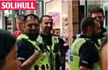  ??  ?? Paw and order: Police help calm warring shoppers SOLIHULL