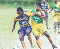  ??  ?? Ruseas Highs Ornell Forbes (left) and Knockalva High s Trey Tomlinson battle for the ball during their ISSA-FLOW daCosta Cup match at Rusea s High on October 4. Rusea s won the game 3-0.
