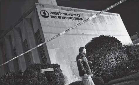  ?? Brendan Smialowski / AFP /Getty Images ?? An FBI agent stands outside the Tree of Life Synagogue in Pittsburgh after a shooting there left 11 people dead and six injured on Oct. 27.