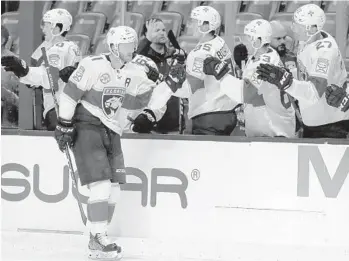  ?? LYNNE SLADKY/AP ?? Panthers left wing Jonathan Huberdeau is congratula­ted after scoring a goal during the first period of a preseason game against the Lightning on Saturday in Sunrise. Huberdeau scored 69 points last season (27 goals, 42 assists).