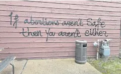  ?? REUTERS ?? A threat is spray painted on the building wall near Wisconsin Family Action’s offices in Madison, Wisconsin on Sunday.