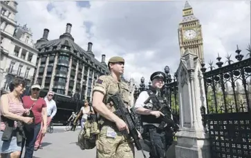  ?? Carl Court Getty Images ?? SECURITY FORCES on patrol in London. “We will win this fight” against terrorism, President Trump said.