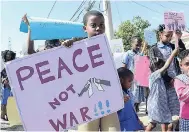  ?? FILE ?? Students and teachers of Obistan Kinder-Preparator­y School march through the streets of Pembroke Hall in St Andrew during a march for peace on Peace Day last year.