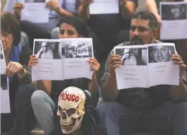  ??  ?? Journalist­s, one wearing a fake scull and others holding photos of slain colleagues, call attention to the latest wave of killings of members of the media as they protest at the Angel of Independen­ce monument in Mexico City, Tuesday, May 30, 2017. In...