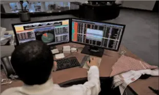  ?? -AFP ?? RIYADH
A Saudi trader observes the stock market on monitors at Falcom stock exchange agency in Riyadh, Saudi Arabia.