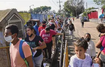  ?? Marco Ugarte/Associated Press ?? Migrants wait on Oct. 4 for their turn to apply for legal migration documents outside Mexico’s National Immigratio­n Institute — deemed the most corrupt institutio­n by the nation’s president.