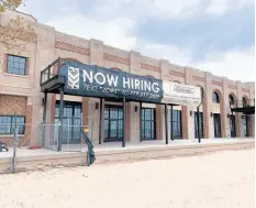  ?? AMY LAVALLEY/POST-TRIBUNE ?? Banners on the renovated pavilion at Indiana Dunes State Park on Tuesday announce job openings for the facility.