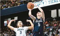 ?? GREG FIUME/GETTY ?? Uconn’s Paige Bueckers shoots the ball in the second quarter past Georgetown’s Victoria Rivera on Sunday at Entertainm­ent & Sports Arena in Washington, DC.