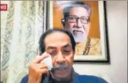  ?? SATISH BATE/HT ?? A video grab of CM Uddhav Thackeray (top) getting emotional while addressing Shiv Sena cadres virtually from his family residence Matoshree; and minister Aaditya Thackeray greeting party workers outside Sena Bhawan, in Mumbai.