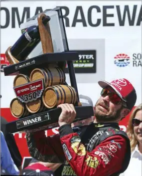  ?? BEN MARGOT — THE ASSOCIATED PRESS ?? Martin Truex Jr. raises the trophy after winning a NASCAR Sprint Cup Series auto race Sunday in Sonoma