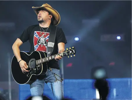  ??  ?? Country superstar Jason Aldean was on stage when a gunman fired into a crowd of concertgoe­rs in Las Vegas on Oct. 1.